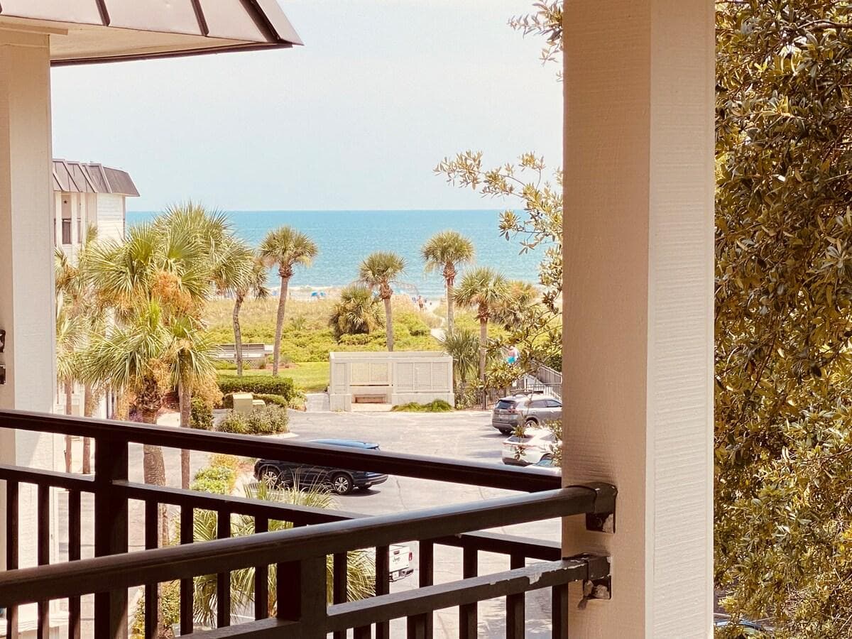 Yes, this is the actual view from the balcony.
Yes, you can see the actual sand on the beach :-)